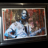 Framed picture of a singer with a guitar